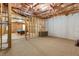 Unfinished basement with framed walls, exposed insulation, and carpeted flooring at 5003 Pacific Dunes Dr, Suwanee, GA 30024
