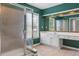 Bright bathroom featuring a glass shower, vanity and large mirror at 5003 Pacific Dunes Dr, Suwanee, GA 30024