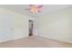 This bedroom has neutral walls, carpet flooring, a ceiling fan, and 2 windows at 5003 Pacific Dunes Dr, Suwanee, GA 30024