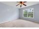Comfortable bedroom with natural light and a ceiling fan at 5003 Pacific Dunes Dr, Suwanee, GA 30024