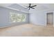 Bright and spacious bedroom with neutral carpet, tray ceiling and light-filled windows at 5003 Pacific Dunes Dr, Suwanee, GA 30024