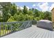 Exterior wooden deck overlooking lush, mature landscaping at 5003 Pacific Dunes Dr, Suwanee, GA 30024