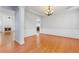 Elegant dining room featuring hardwood floors, wainscoting, a tray ceiling, and a chandelier at 5003 Pacific Dunes Dr, Suwanee, GA 30024