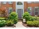 Close-up of an inviting front entrance, featuring a brick facade and professionally landscaped garden at 5003 Pacific Dunes Dr, Suwanee, GA 30024