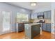 Modern kitchen with stainless steel appliances, granite countertops, and a functional island at 5003 Pacific Dunes Dr, Suwanee, GA 30024