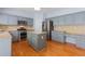 Spacious kitchen boasting stainless steel appliances, a center island, and ample counter space at 5003 Pacific Dunes Dr, Suwanee, GA 30024