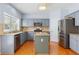 Well-equipped kitchen features a stainless steel refrigerator and a convenient center island at 5003 Pacific Dunes Dr, Suwanee, GA 30024