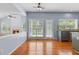 Open floor plan with eat-in kitchen featuring light-filled windows and hardwood flooring at 5003 Pacific Dunes Dr, Suwanee, GA 30024