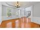 Inviting living area with hardwood floors, wainscoting, large windows, and open floor plan at 5003 Pacific Dunes Dr, Suwanee, GA 30024