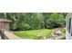 Scenic backyard with a lush lawn, patio, landscaping, and a wooded view at 1620 Stonecliff Dr, Decatur, GA 30033
