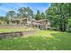 Expansive brick home with terraced yard, beautiful landscaping, and mature trees at 1620 Stonecliff Dr, Decatur, GA 30033