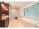 Bright bathroom boasting a separate shower, a soaking tub, and and sinks at 1620 Stonecliff Dr, Decatur, GA 30033