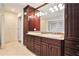 Bathroom featuring double sinks, wood cabinets, granite countertops, and tile floor at 1620 Stonecliff Dr, Decatur, GA 30033