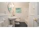 Bright bathroom featuring a white vanity, subway tile, and black honeycomb-patterned floor at 1620 Stonecliff Dr, Decatur, GA 30033