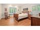 Cozy bedroom with wood floors, a rocking chair, and a large window letting in natural light at 1620 Stonecliff Dr, Decatur, GA 30033