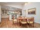 Cozy dining area next to a bright kitchen with white cabinets and wood flooring at 1620 Stonecliff Dr, Decatur, GA 30033