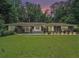 Charming brick home with manicured lawn and inviting front porch seating at 1620 Stonecliff Dr, Decatur, GA 30033