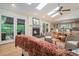 Sunlit living room features a fireplace, wood floors, and access to an outdoor deck at 1620 Stonecliff Dr, Decatur, GA 30033