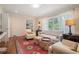 Comfortable living room featuring hardwood floors, a plush sofa, and bright windows at 1620 Stonecliff Dr, Decatur, GA 30033