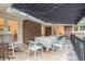 Covered patio with stone flooring, dining set, and retractable awning for outdoor enjoyment at 1620 Stonecliff Dr, Decatur, GA 30033