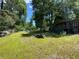 Backyard view featuring grass, trees, and stacked planks at 195 Darla Dr, Woodstock, GA 30188