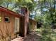 Exterior view of a rustic home with a brick chimney and side door at 195 Darla Dr, Woodstock, GA 30188