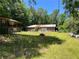 Exterior view of the side of the home and the outbuilding on the property at 195 Darla Dr, Woodstock, GA 30188