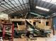 Large garage space featuring multiple vehicles and a high ceiling, offering potential for storage or workshop capabilities at 195 Darla Dr, Woodstock, GA 30188