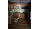 Kitchen with wood cabinets, a black microwave, stainless steel sink, and wood floors at 195 Darla Dr, Woodstock, GA 30188