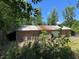 Side view of outbuilding featuring a large garage door and metal roof at 195 Darla Dr, Woodstock, GA 30188