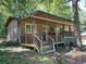 Covered wooden porch with seating; part of a rustic, cabin-style home at 195 Darla Dr, Woodstock, GA 30188