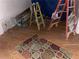 A bare room is shown, with ladders, boxes of Bruce hardwood, and a multi-colored rug at 195 Darla Dr, Woodstock, GA 30188