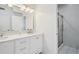 Bright bathroom featuring dual sinks, white cabinets, and a glass-enclosed shower at 2268 Orleans Ave, Marietta, GA 30062