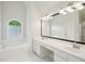 Bright bathroom with a soaking tub, double vanity, and modern fixtures at 2268 Orleans Ave, Marietta, GA 30062
