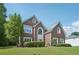Inviting two-story brick home with a lush green lawn and mature trees in a suburban setting at 2268 Orleans Ave, Marietta, GA 30062