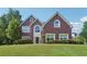 Beautiful brick two-story home with well-manicured lawn and mature trees on a sunny day at 2268 Orleans Ave, Marietta, GA 30062