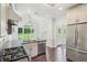Modern kitchen with stainless steel appliances, hardwood floors, island sink and ample natural light at 2268 Orleans Ave, Marietta, GA 30062