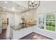 Bright kitchen with stainless appliances, light wood cabinets and black countertops next to window at 2268 Orleans Ave, Marietta, GA 30062
