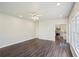 Open living room with hardwood floors and a view into the kitchen with stainless appliances at 2268 Orleans Ave, Marietta, GA 30062