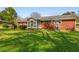 Spacious backyard featuring a well-maintained lawn and a red brick home exterior at 3031 Walker Dr, Marietta, GA 30062