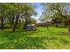 Expansive backyard with lush green grass and mature trees, plus a storage shed at 3031 Walker Dr, Marietta, GA 30062