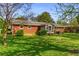 Well-manicured backyard with a brick house, sunroom, and ample greenery at 3031 Walker Dr, Marietta, GA 30062