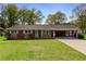 Inviting single-Gathering home showcasing a lush green lawn and covered parking at 3031 Walker Dr, Marietta, GA 30062