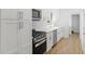 Modern kitchen featuring white cabinets, stainless steel appliances, and quartz countertops at 3031 Walker Dr, Marietta, GA 30062