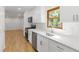 Well-lit kitchen showcases stainless steel appliances and quartz countertops and white cabinets at 3031 Walker Dr, Marietta, GA 30062