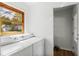 Convenient laundry room featuring a washer and dryer, natural light, and storage space at 3031 Walker Dr, Marietta, GA 30062