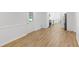 Open-concept living area with hardwood floors, white walls, and access to the kitchen at 3031 Walker Dr, Marietta, GA 30062