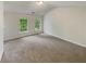 This bedroom boasts neutral paint and carpet along with dual windows offering a great view at 6240 Shenfield Ln, Union City, GA 30291