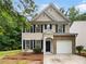 Charming two-story home with brick accents, a well-manicured lawn, and a welcoming front entrance at 6240 Shenfield Ln, Union City, GA 30291