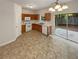 Eat-in kitchen with wood cabinets, white appliances, and a sliding glass door to the backyard at 6240 Shenfield Ln, Union City, GA 30291